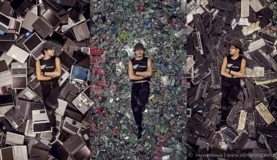 Photographer Benjamin Von Wong lies among the pile of e-waste.