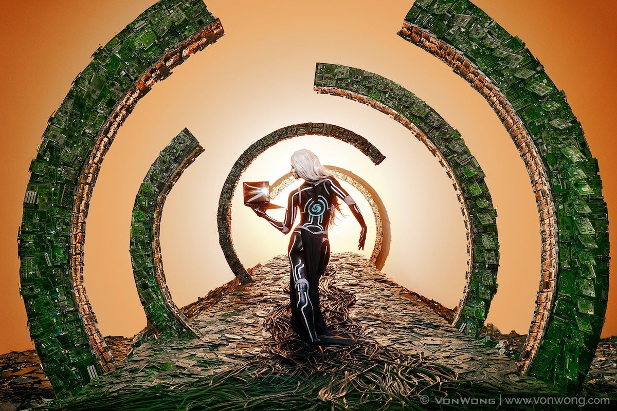 Photo #2: A model stands among cables and circuit board arches.